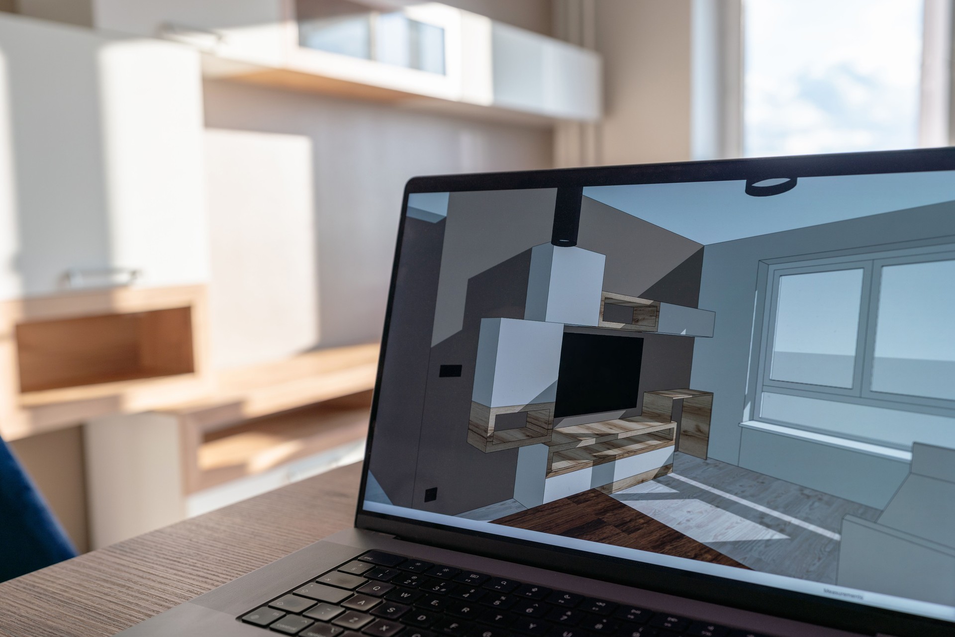 Laptop on the kitchen table with sketch 3d model of this apartment on the screen